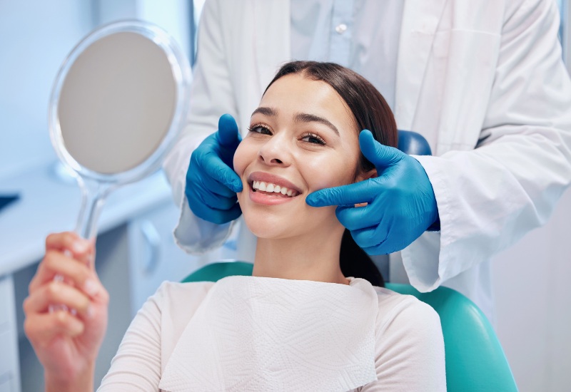 A smiling woman receives a dental cleaning at Complete Dental Services in Charles Town, WV.