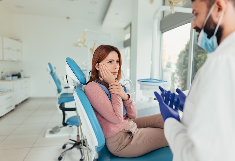 A dentist explaining the benefits of a root canal over extraction to a patient in Charles Town, WV